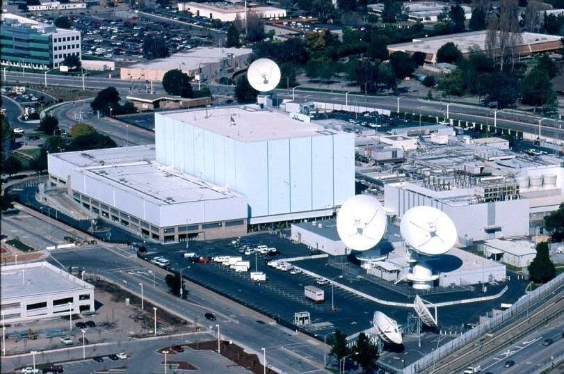 Aerial view of Onizuka Air Station in Sunnyvale, California — the windowless building known as the Blue Cube, ringed by satellite dishes